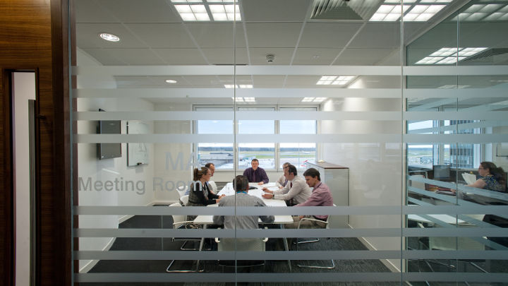 The meeting room of Manchester Airport Olympic House illuminated by Philips led office lighting.